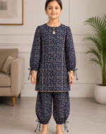 Girl wearing navy floral printed co-ord set with tie-knot sleeves by Yarn Every Style.